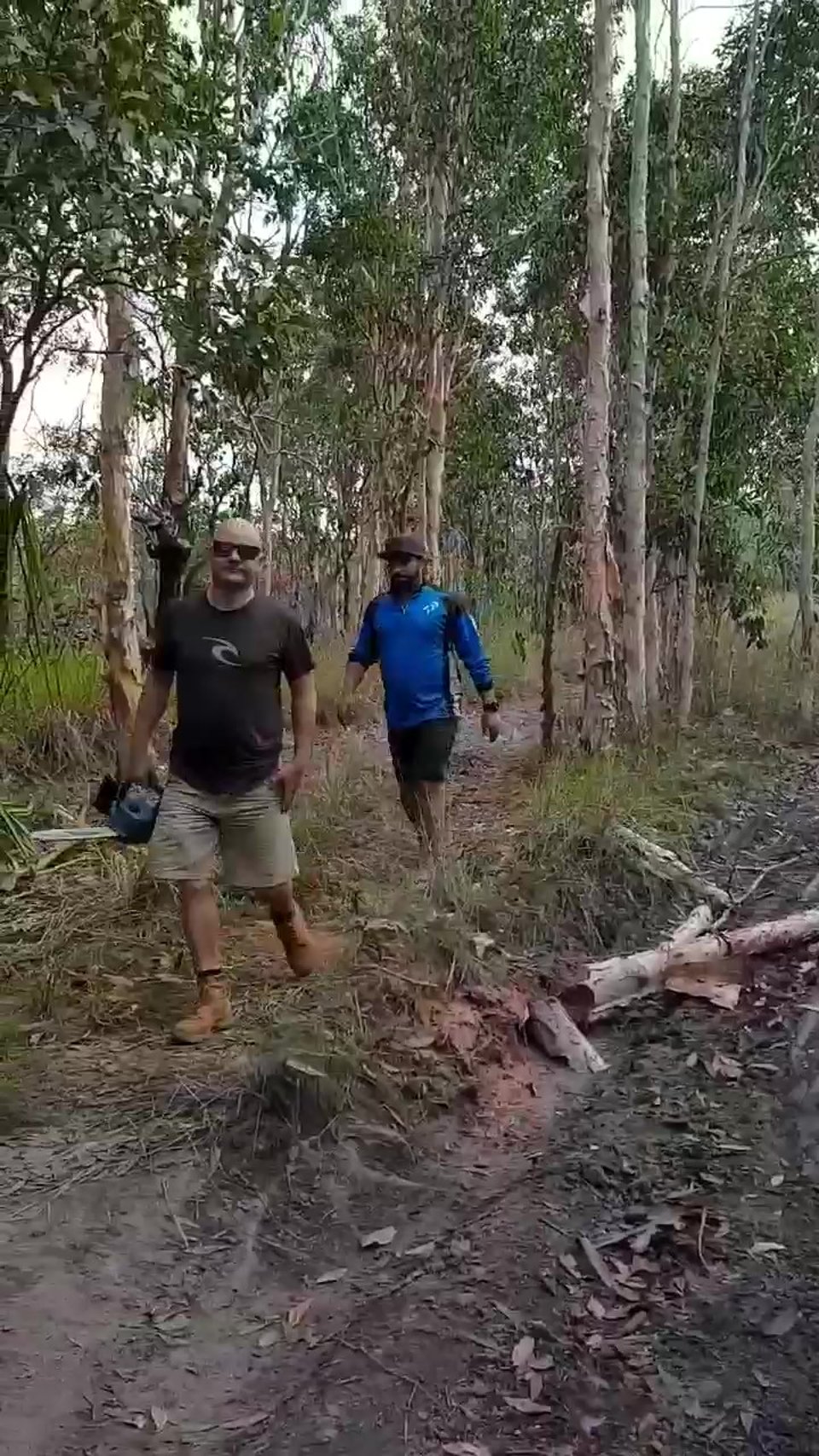 Col and Angry cutting down a tree so we could squeeze through, near Gunn Point NT